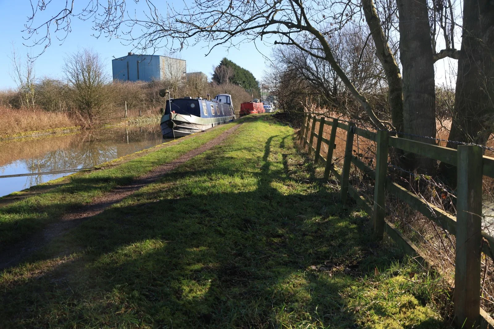 A narrowboat beside a canal towpath in the United Kingdom